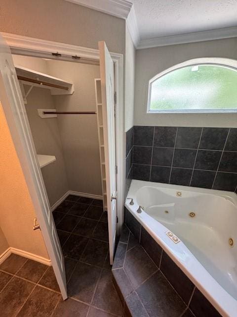 bathroom with crown molding, a jetted tub, and tile patterned flooring