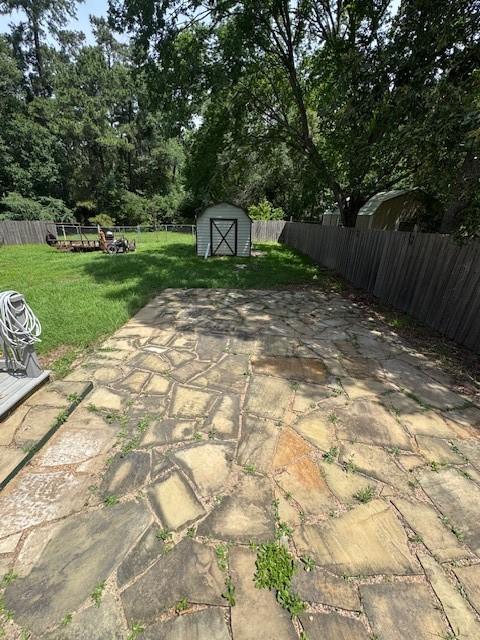 view of patio / terrace with a shed and an outbuilding