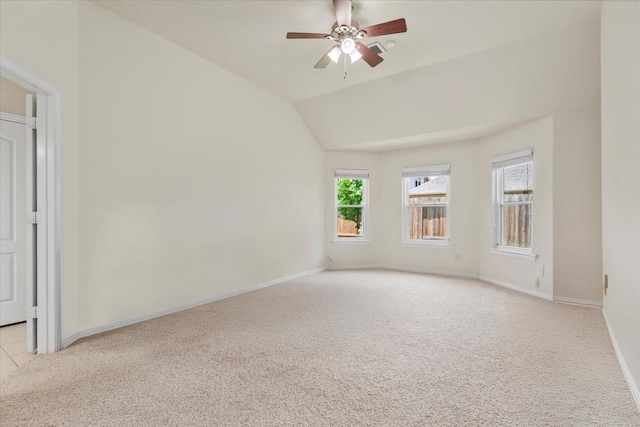 unfurnished room with light colored carpet, a ceiling fan, baseboards, and lofted ceiling