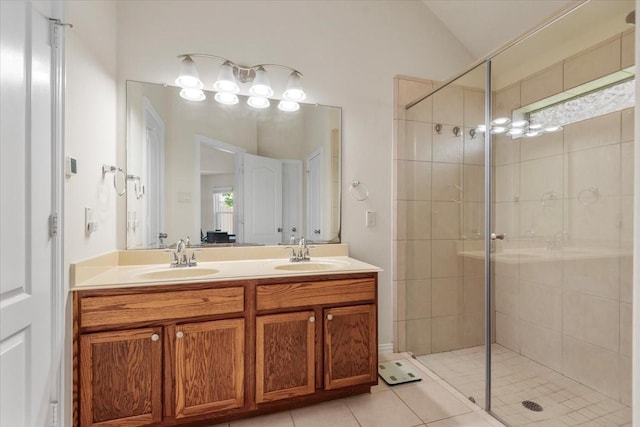 full bath with a stall shower, vaulted ceiling, tile patterned flooring, and double vanity