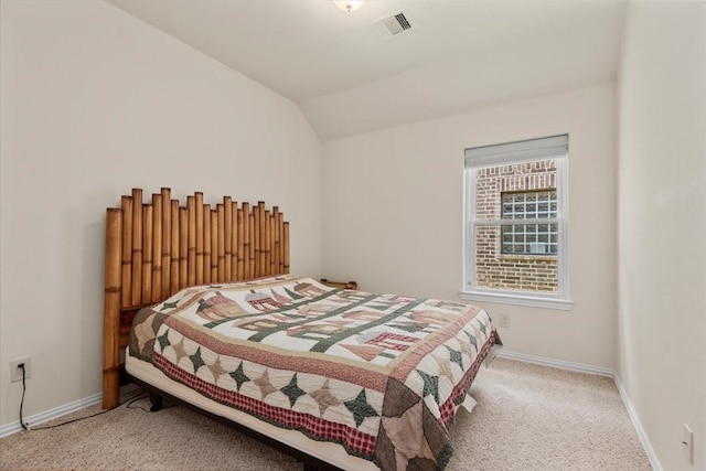 bedroom featuring carpet floors, baseboards, and vaulted ceiling