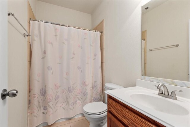 full bath with toilet, vanity, tile patterned floors, and a shower with curtain