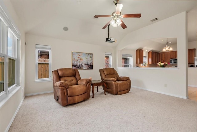sitting room featuring vaulted ceiling, light colored carpet, ceiling fan, and baseboards