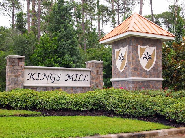 community / neighborhood sign with a lawn