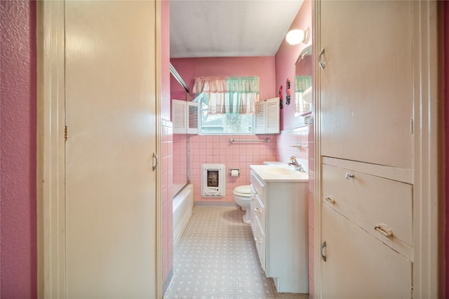 5402 Tallow Ln, Houston, TX 77021 - full bathroom with toilet, vanity, heating unit, shower / washtub combination, and tile walls