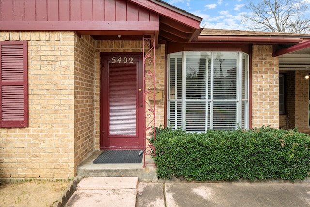 5402 Tallow Ln, Houston, TX 77021 - view of exterior entry featuring brick siding and board and batten siding