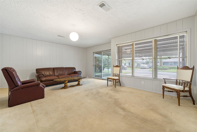 5402 Tallow Ln, Houston, TX 77021 - carpeted living area featuring a decorative wall and a textured ceiling