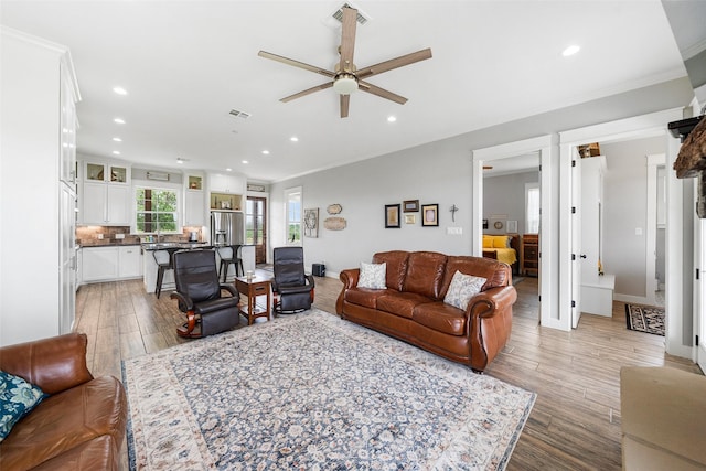 3785 County Road 405, Anderson, TX 77830 - living room with crown molding, a ceiling fan, light wood-style floors, recessed lighting, and baseboards