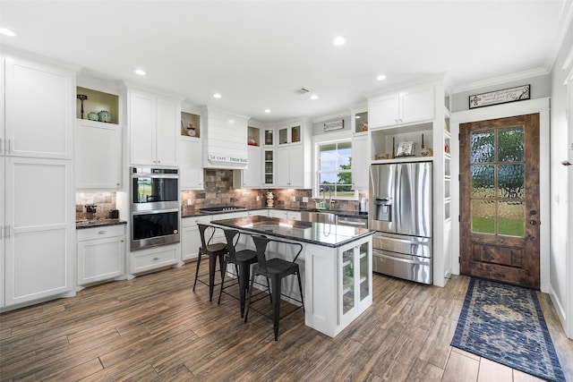 3785 County Road 405, Anderson, TX 77830 - kitchen featuring stainless steel appliances, open shelves, crown molding, a kitchen breakfast bar, and white cabinetry