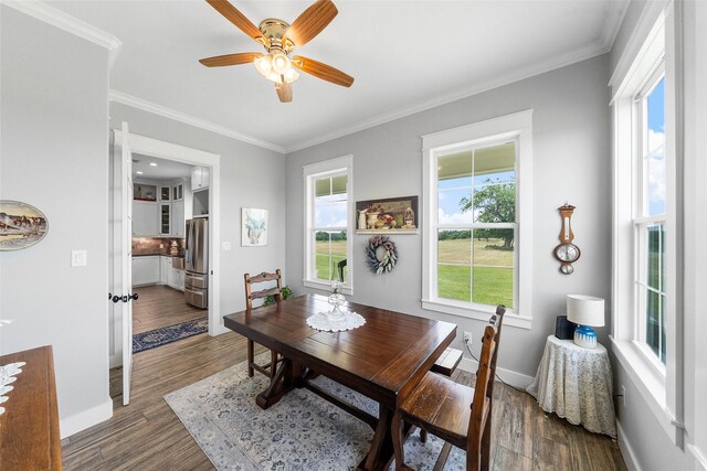 3785 County Road 405, Anderson, TX 77830 - dining space featuring crown molding, a ceiling fan, dark wood finished floors, and baseboards