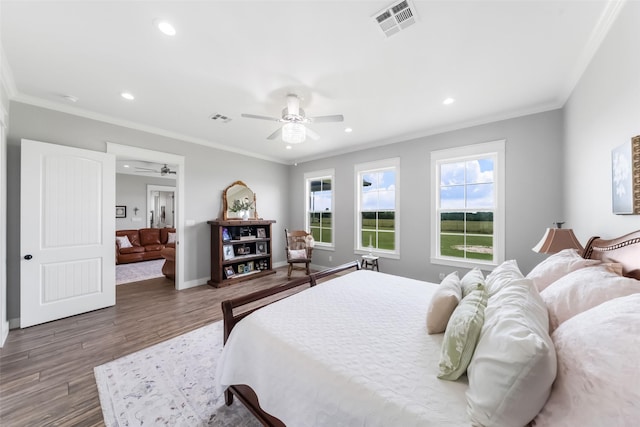 3785 County Road 405, Anderson, TX 77830 - bedroom with wood finished floors, ornamental molding, recessed lighting, a ceiling fan, and baseboards