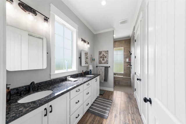 3785 County Road 405, Anderson, TX 77830 - full bathroom with plenty of natural light, a tile shower, wood finished floors, ornamental molding, and double vanity