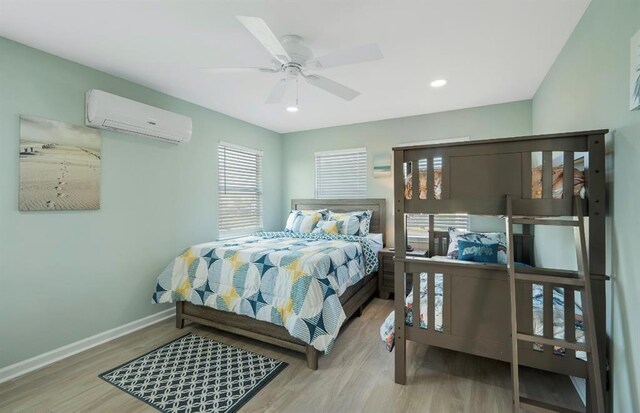 1019 Treaty Dr, Surfside Beach, TX 77541 - bedroom with a wall mounted air conditioner, multiple windows, wood finished floors, and recessed lighting