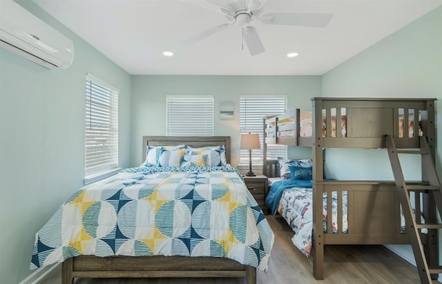 1019 Treaty Dr, Surfside Beach, TX 77541 - bedroom featuring a wall mounted AC, multiple windows, wood finished floors, recessed lighting, and a ceiling fan