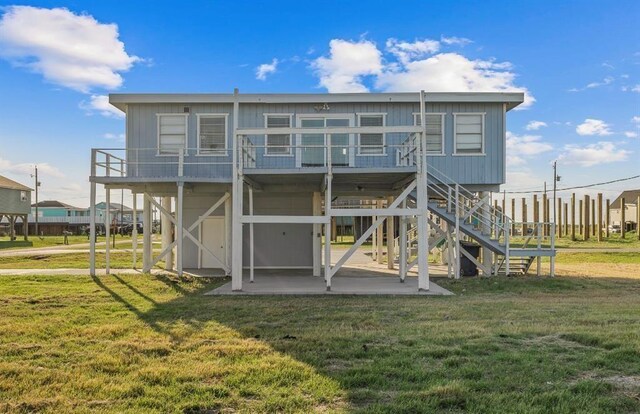 1019 Treaty Dr, Surfside Beach, TX 77541 - rear view of property featuring a patio, a lawn, stairway, and a deck
