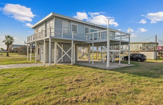 1019 Treaty Dr, Surfside Beach, TX 77541 - back of house with a yard, a deck, and stairs