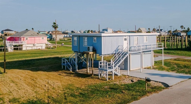 1019 Treaty Dr, Surfside Beach, TX 77541 - exterior space featuring a front lawn, stairway, and a residential view