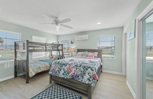 1019 Treaty Dr, Surfside Beach, TX 77541 - bedroom featuring a wall mounted AC, multiple windows, baseboards, wood finished floors, and recessed lighting