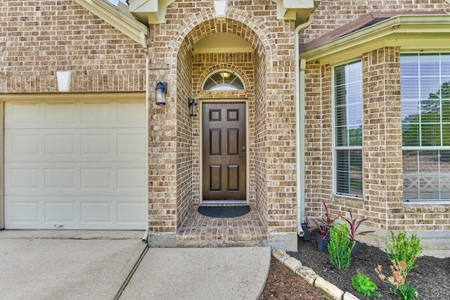 3729 Breckenridge Dr, Montgomery, TX 77356 - view of exterior entry with brick siding, driveway, and a garage