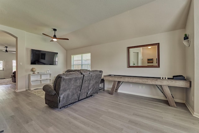 3729 Breckenridge Dr, Montgomery, TX 77356 - living area featuring ceiling fan, light wood finished floors, lofted ceiling, arched walkways, and baseboards