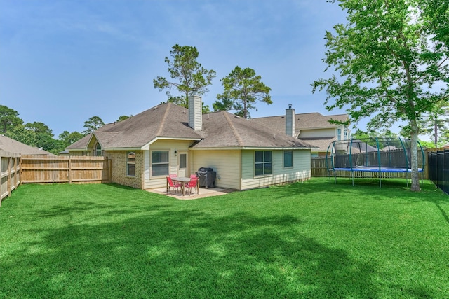 3729 Breckenridge Dr, Montgomery, TX 77356 - back of property featuring a trampoline, a patio area, a chimney, and roof with shingles