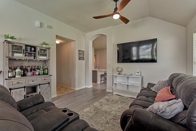 3729 Breckenridge Dr, Montgomery, TX 77356 - living room featuring wood finished floors, a ceiling fan, arched walkways, lofted ceiling, and baseboards
