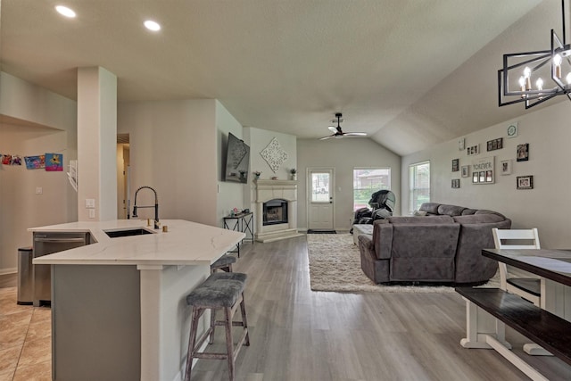 3729 Breckenridge Dr, Montgomery, TX 77356 - living room with a ceiling fan, a fireplace with raised hearth, lofted ceiling, recessed lighting, and baseboards