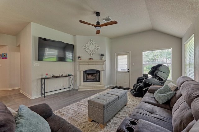 3729 Breckenridge Dr, Montgomery, TX 77356 - living area with ceiling fan, wood finished floors, a fireplace with raised hearth, vaulted ceiling, and baseboards