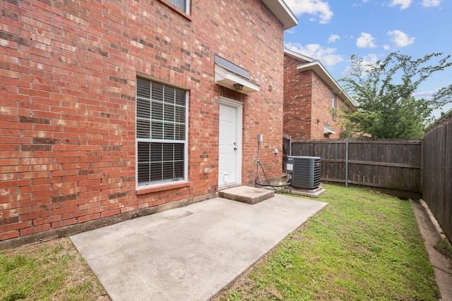 1001 Krenek Tap Rd Unit 1501, College Station, TX 77840 - doorway to property featuring central air condition unit, brick siding, and a patio