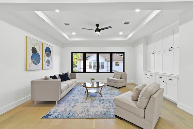 5115 Maple St, Houston, TX 77401 - living room with a tray ceiling, light wood-type flooring, a ceiling fan, baseboards, and recessed lighting