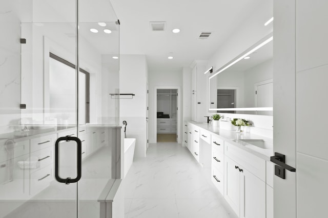5115 Maple St, Houston, TX 77401 - full bath featuring marble look tile flooring, recessed lighting, a freestanding tub, double vanity, and a shower stall