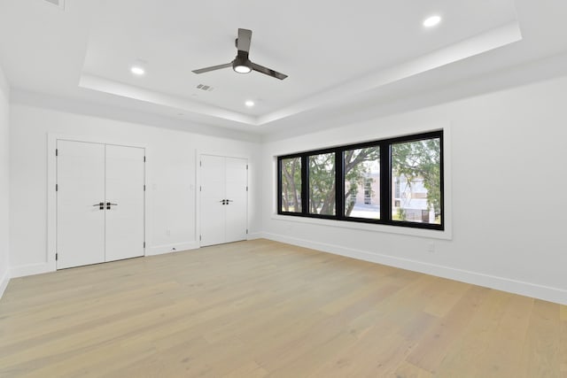 5115 Maple St, Houston, TX 77401 - unfurnished bedroom featuring a raised ceiling, multiple closets, light wood finished floors, baseboards, and recessed lighting