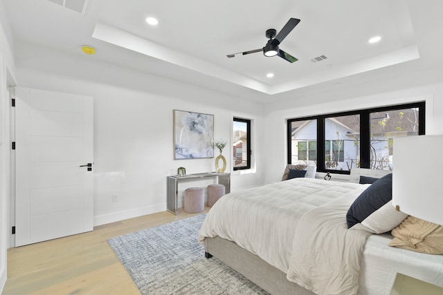 5115 Maple St, Houston, TX 77401 - bedroom featuring a tray ceiling, recessed lighting, light wood finished floors, baseboards, and access to outside