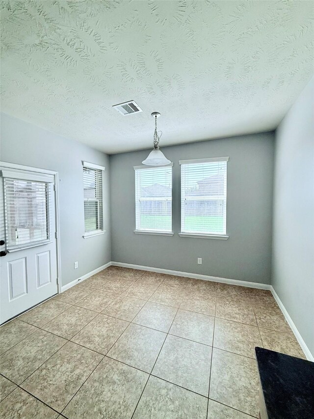 13938 Kenswick Key Ln, Houston, TX 77047 - empty room featuring light tile patterned floors, baseboards, and a textured ceiling