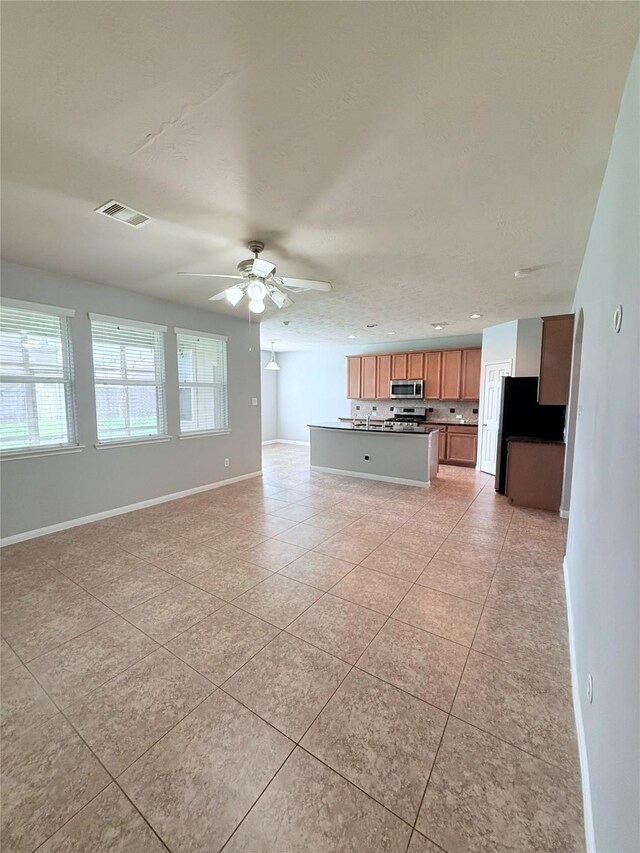 13938 Kenswick Key Ln, Houston, TX 77047 - unfurnished living room featuring light tile patterned flooring, a ceiling fan, baseboards, and recessed lighting