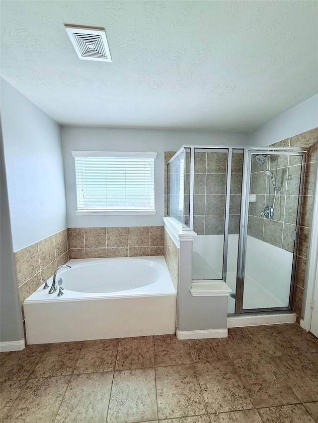 13938 Kenswick Key Ln, Houston, TX 77047 - full bath with a stall shower, a garden tub, and a textured ceiling