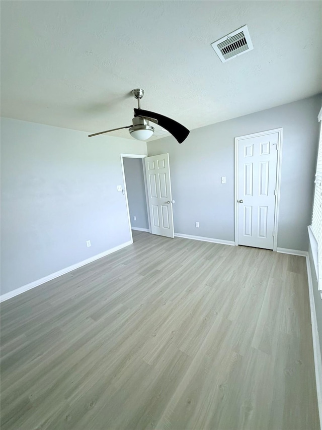 13938 Kenswick Key Ln, Houston, TX 77047 - unfurnished bedroom with baseboards, light wood-type flooring, and a ceiling fan