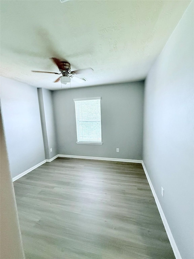 13938 Kenswick Key Ln, Houston, TX 77047 - empty room with ceiling fan, baseboards, and wood finished floors