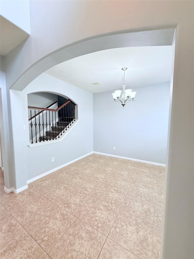 13938 Kenswick Key Ln, Houston, TX 77047 - unfurnished room with tile patterned flooring, a chandelier, stairs, and arched walkways