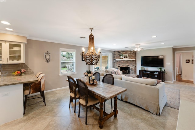 8914 Railton St, Houston, TX 77080 - dining room with a brick fireplace, light tile patterned floors, recessed lighting, ornamental molding, and ceiling fan