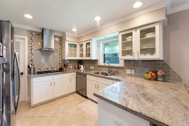 8914 Railton St, Houston, TX 77080 - kitchen featuring a sink, appliances with stainless steel finishes, wall chimney exhaust hood, light stone countertops, and decorative backsplash