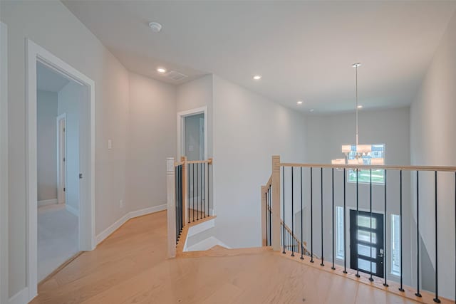 21714 Jenolan Ridge Rd, Cypress, TX 77433 - corridor with an upstairs landing, wood finished floors, a chandelier, and recessed lighting