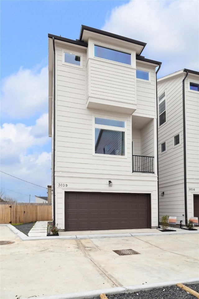 303D Marcella St, Houston, TX 77091 - view of front facade featuring a garage, concrete driveway, and fence