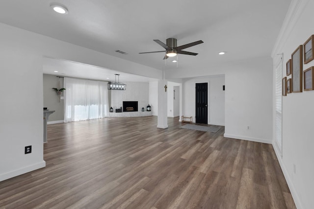 100 Longacre Dr, Conroe, TX 77304 - unfurnished living room with a brick fireplace, a ceiling fan, dark wood-type flooring, baseboards, and recessed lighting
