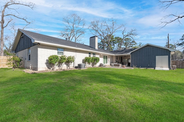 100 Longacre Dr, Conroe, TX 77304 - rear view of property with an outdoor hangout area, a chimney, brick siding, a patio, and board and batten siding