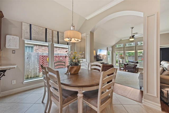 27438 Channing Springs Dr, Spring, TX 77386 - dining space with vaulted ceiling, ceiling fan, light tile patterned floors, arched walkways, and baseboards