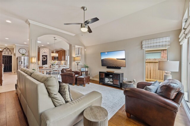 27438 Channing Springs Dr, Spring, TX 77386 - living area featuring ceiling fan, arched walkways, light wood finished floors, ornamental molding, and lofted ceiling