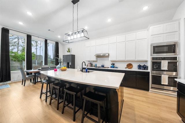 15040 Berry Brook Dr, Conroe, TX 77302 - kitchen with a sink, appliances with stainless steel finishes, recessed lighting, light countertops, and an island with sink