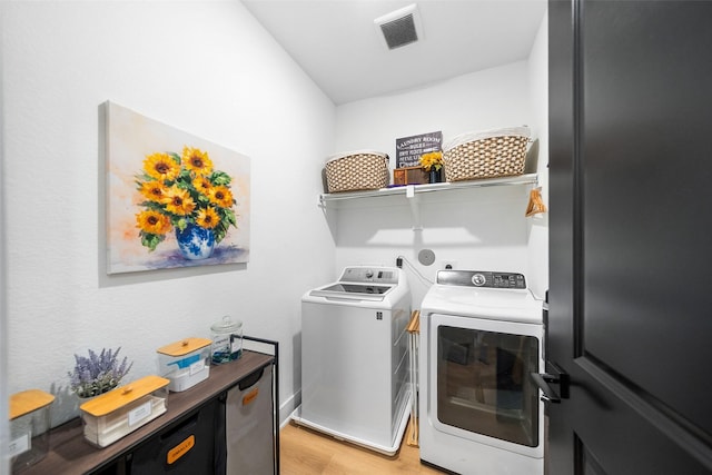 15040 Berry Brook Dr, Conroe, TX 77302 - washroom featuring washing machine and dryer and light wood-style floors