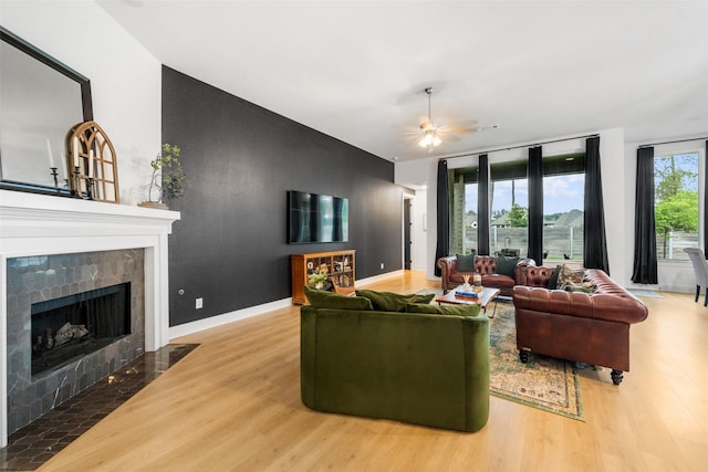 15040 Berry Brook Dr, Conroe, TX 77302 - living area featuring wood finished floors, a fireplace, and ceiling fan